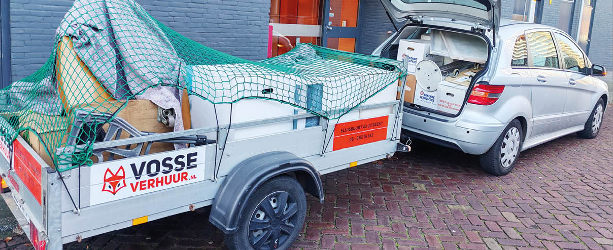 A red truck is parked in front of a brick building. AI generated content