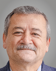 A man wearing a purple sweater. Description generated by AI