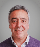 A man wearing a purple sweater. Description generated by AI