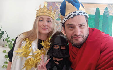 A man and a woman are wearing costumes and posing for a picture. Description generated by AI