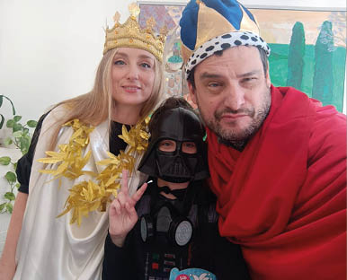 A man and a woman are wearing costumes and posing for a picture. Description generated by AI