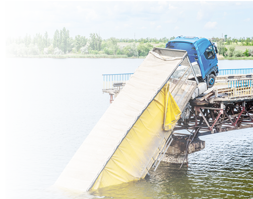 Destruction of bridge structures across the river with the collapse of sections into the water. Truck accident on destroyed bridge