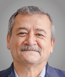 A man wearing a purple sweater. Description generated by AI