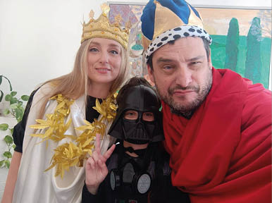 A man and a woman are wearing costumes and posing for a picture. Description generated by AI