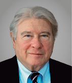 A man wearing a blue shirt and a blue tie. Description generated by AI