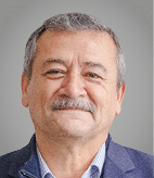 A man wearing a purple sweater. Description generated by AI