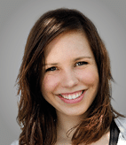 A woman with brown hair and a white shirt. Description generated by AI