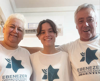 Three people wearing white shirts with a blue star on them. Description generated by AI