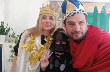 A man and a woman are wearing costumes and posing for a picture. Description generated by AI