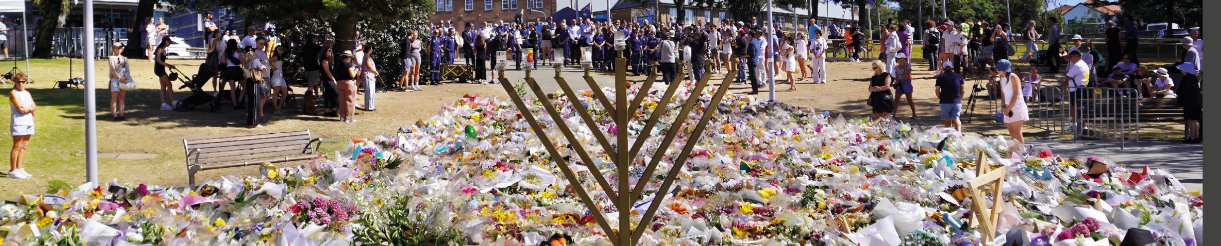 Bondi Beach, Sydney, Australia, December 18, 2025. People gathered around the Flower Memorial outside Bondi Pavilion