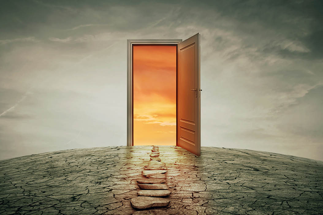 Pathway along a dry, cracked desert land, going to a opened door to another better and colorful world. Road of opportunity and success symbol. Another reality concept. 