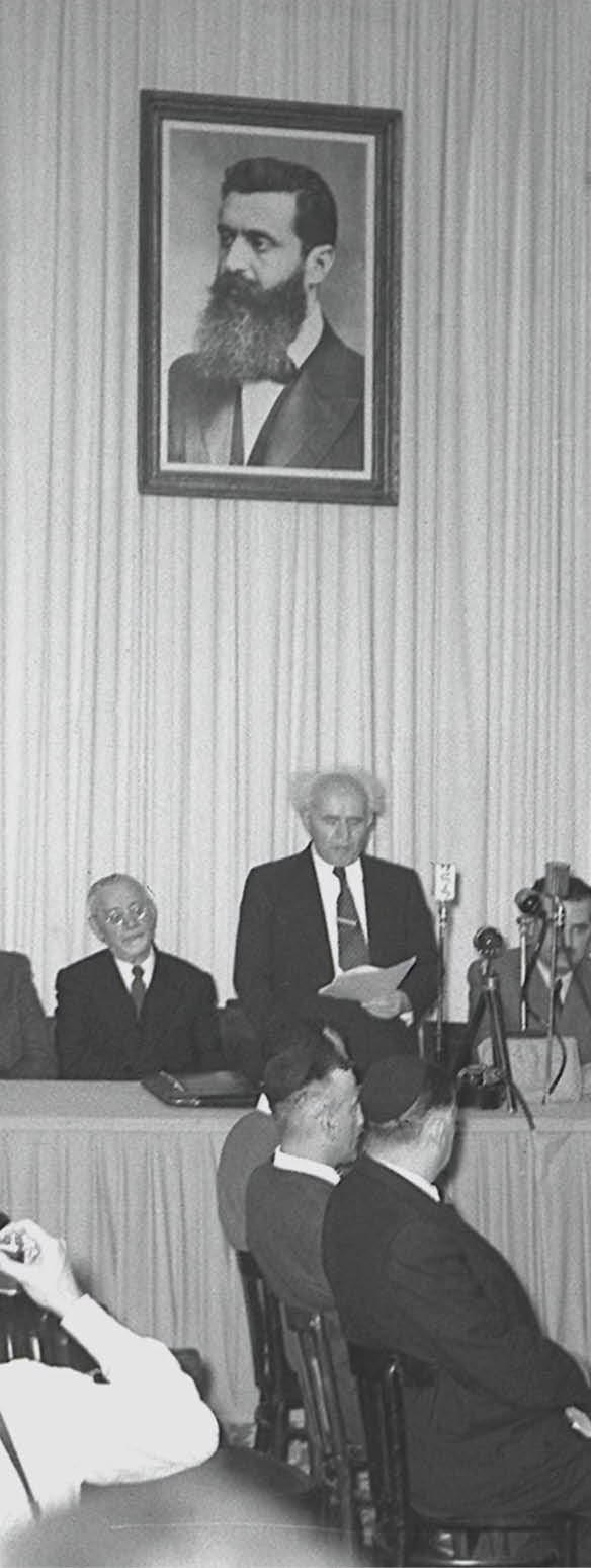 DAVID BEN GURION READING THE DECLARATION OF      INDEPENDENCE OF THE STATE OF ISRAEL DURING THE FESTIV       SESSION IN TEL AVIV MUSEUM ON ROTSCHILD BOULEVARD.  הכרזת העצמאות של מדינת ישראל, במוזיאון תל אביב בשד' רוטשילד.                     ראש הממשלה, דוד בן גוריון קורא את מגילת עצמאות ישראל, בטקס שנערך במוזיאון        תל אביב.