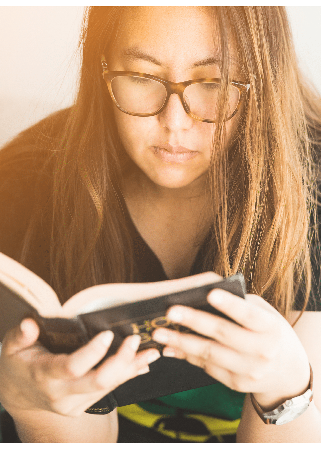 woman praying on holy bible in the morning.