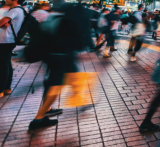 People and traffic cross the famous scramble intersection in Shibuya, Tokyo, Japan, one of the busiest crosswalks in the world