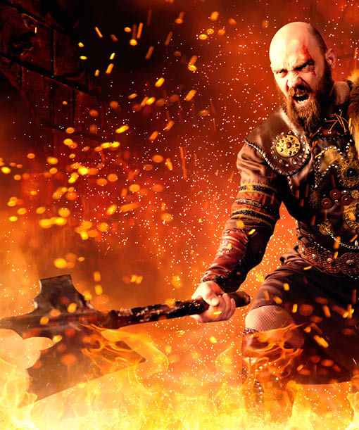 Angry viking with axe dressed in traditional nordic clothes standing in fire, battle in action  Scandinavian ancient warrior