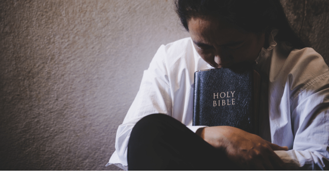 Hands folded in prayer on a Holy Bible in church concept for faith, spirituality and religion, woman praying on holy bible in the morning  woman hand with Bible praying 