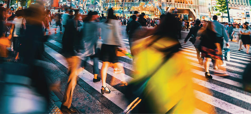 People and traffic cross the famous scramble intersection in Shibuya, Tokyo, Japan, one of the busiest crosswalks in the world