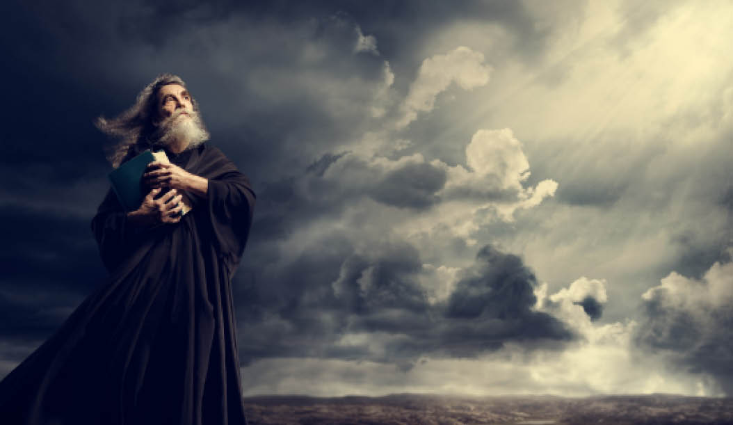 Monk Holding Bible Looking Up to God Sky Light, Old Priest in Black Robe in Storm Mountains