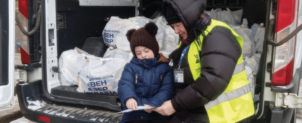 A man and a child are sitting in the back of a truck. Description generated by AI