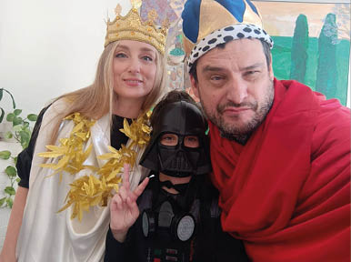A man and a woman are wearing costumes and posing for a picture. Description generated by AI