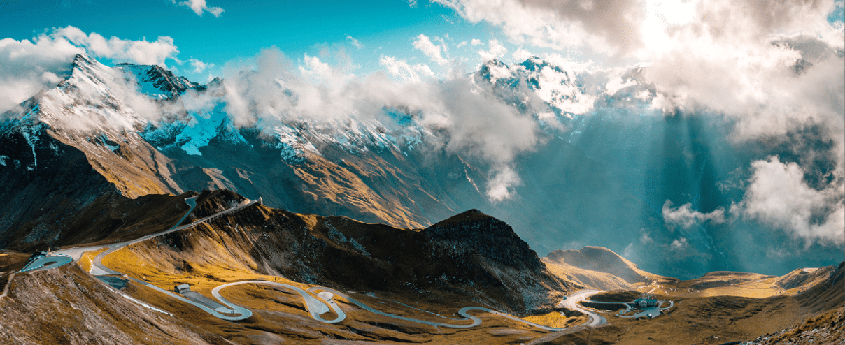 Panoramic Image of Grossglockner Alpine Road. Curvy Winding Road in Alps. Dramatic Sky.