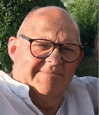 A man wearing glasses and a white shirt. Description generated by AI